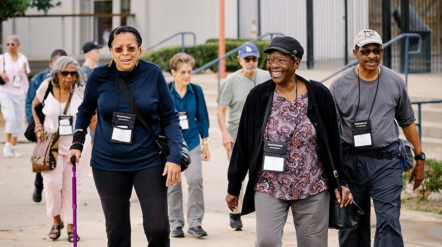 A diverse group of participants on a Civil Rights tour walk together outdoors in Montgomery, Alabama.