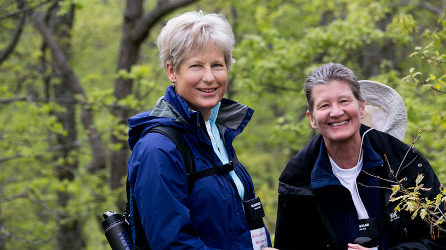 Two women smile for the camera while hiking on the Appalachian Trail in Pennsylvania.