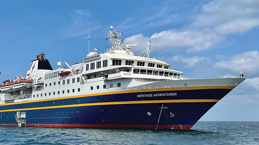 The Heritage Adventurer ship sails in the sea off the coast of Japan and South Korea under a partly cloudy sky.