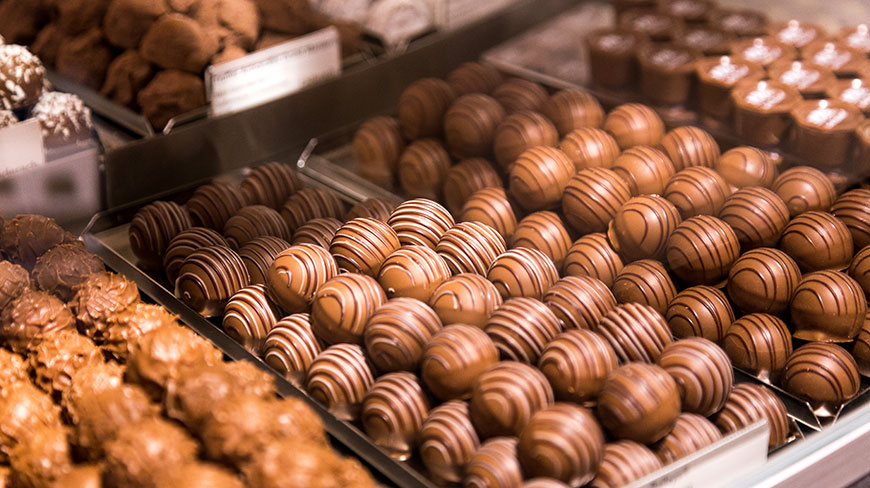Trays of various Swiss chocolate truffles are displayed in a shop in Switzerland.