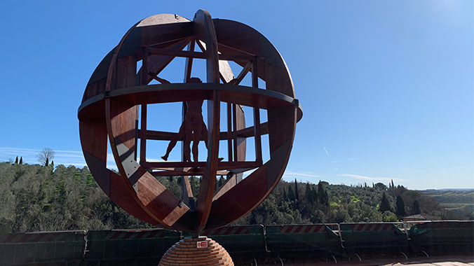 Wooden sculpture of Leonardo Da Vinci's drawing of the Virtruvian Man in a sphere