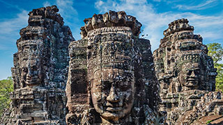 The ancient, carved stone faces of the Bayon Temple at Angkor Wat in Cambodia.