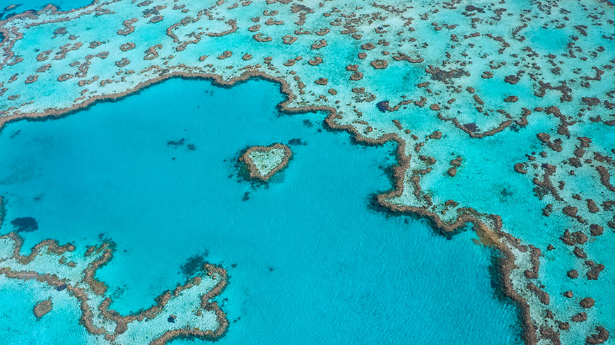 Aerial view of the famous Heart Reef, a natural coral formation within the turquoise waters of the Great Barrier Reef.