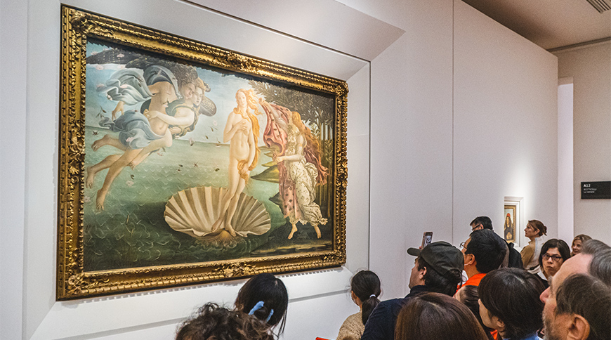 A group of people admire Sandro Botticelli's famous painting, The Birth of Venus, at a museum in Florence, Italy.